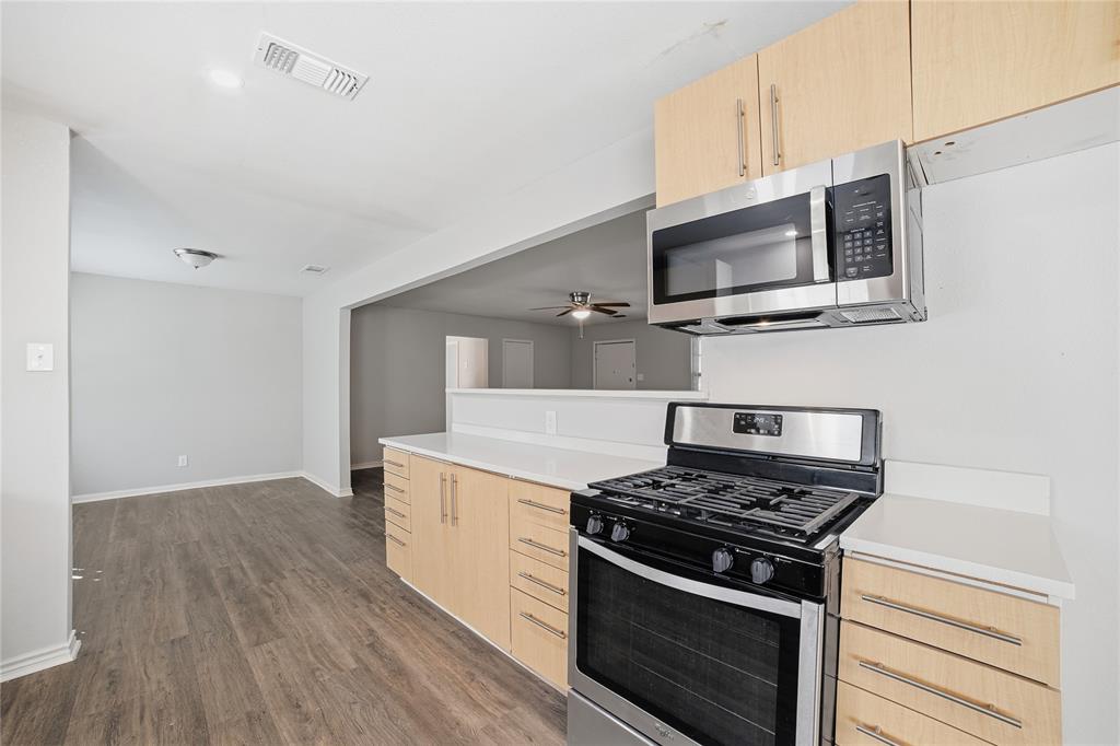 2926 North Prairie Creek Road Dallas, TX 75227 - Photo 11 of 22 a kitchen with a stove and a microwave
