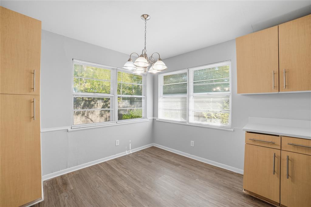 2926 North Prairie Creek Road Dallas, TX 75227 - Photo 12 of 22 a view of an empty room with wooden floor and a window