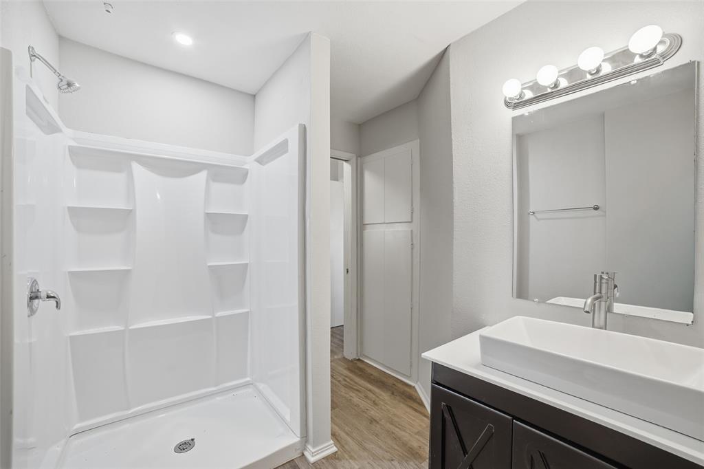 2926 North Prairie Creek Road Dallas, TX 75227 - Photo 14 of 22 a bathroom with a sink a shower and a mirror