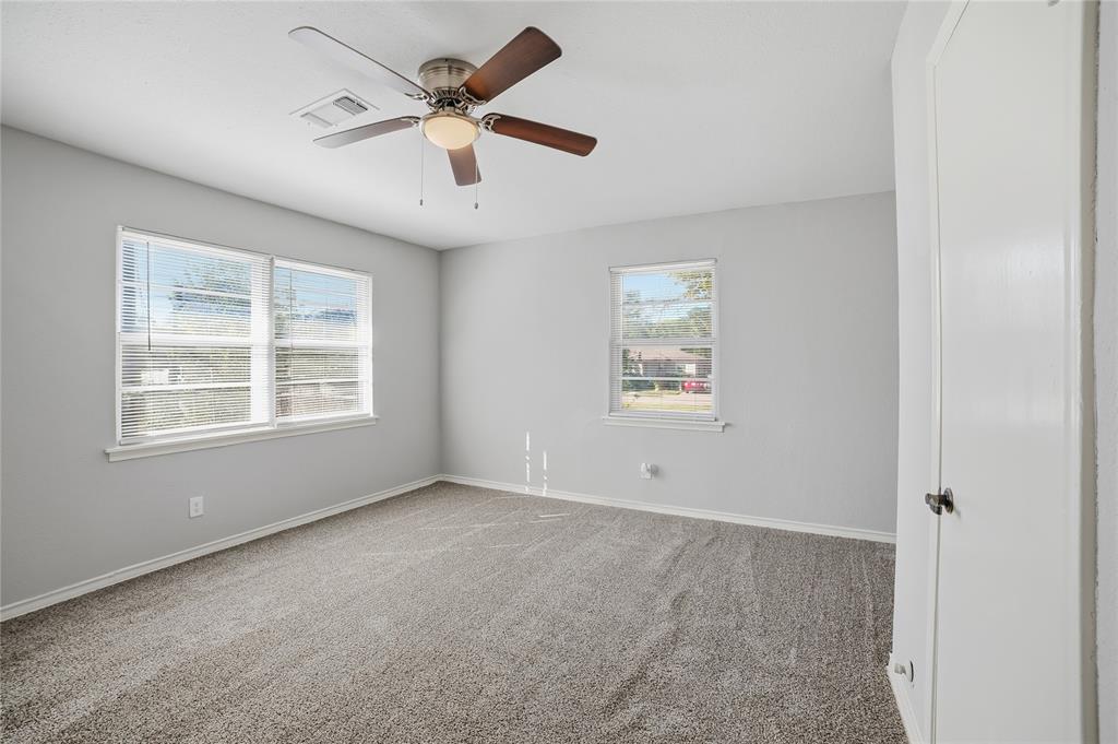 2926 North Prairie Creek Road Dallas, TX 75227 - Photo 15 of 22 an empty room with ceiling fan and windows