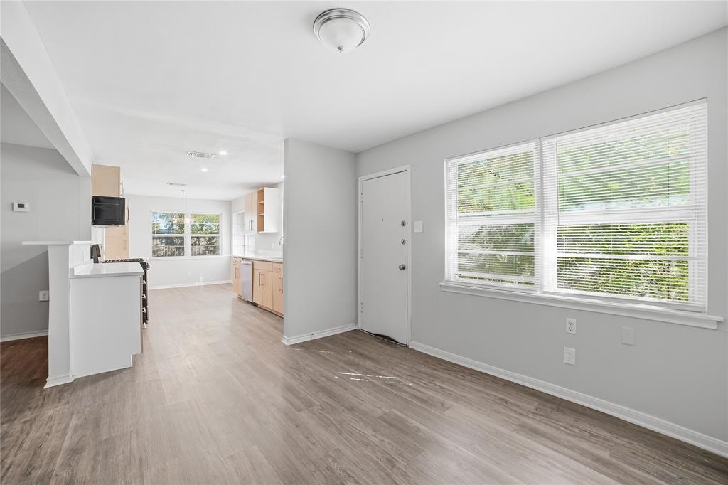 2926 North Prairie Creek Road Dallas, TX 75227 - Photo 3 of 22 wooden floor in an empty room with a window and wooden floor