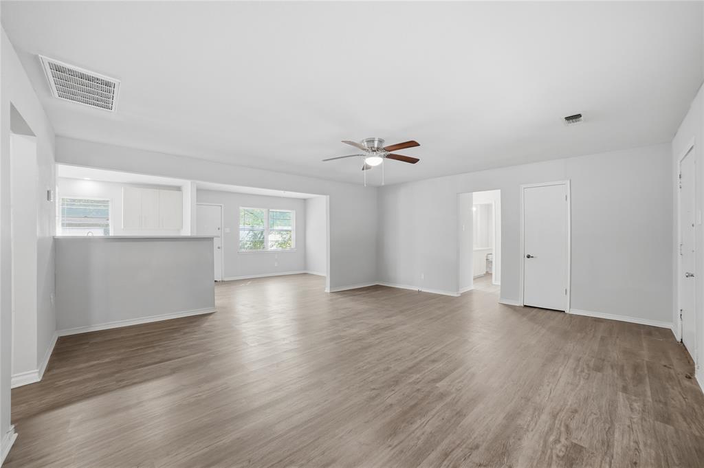 2926 North Prairie Creek Road Dallas, TX 75227 - Photo 6 of 22 an empty room with wooden floor and windows