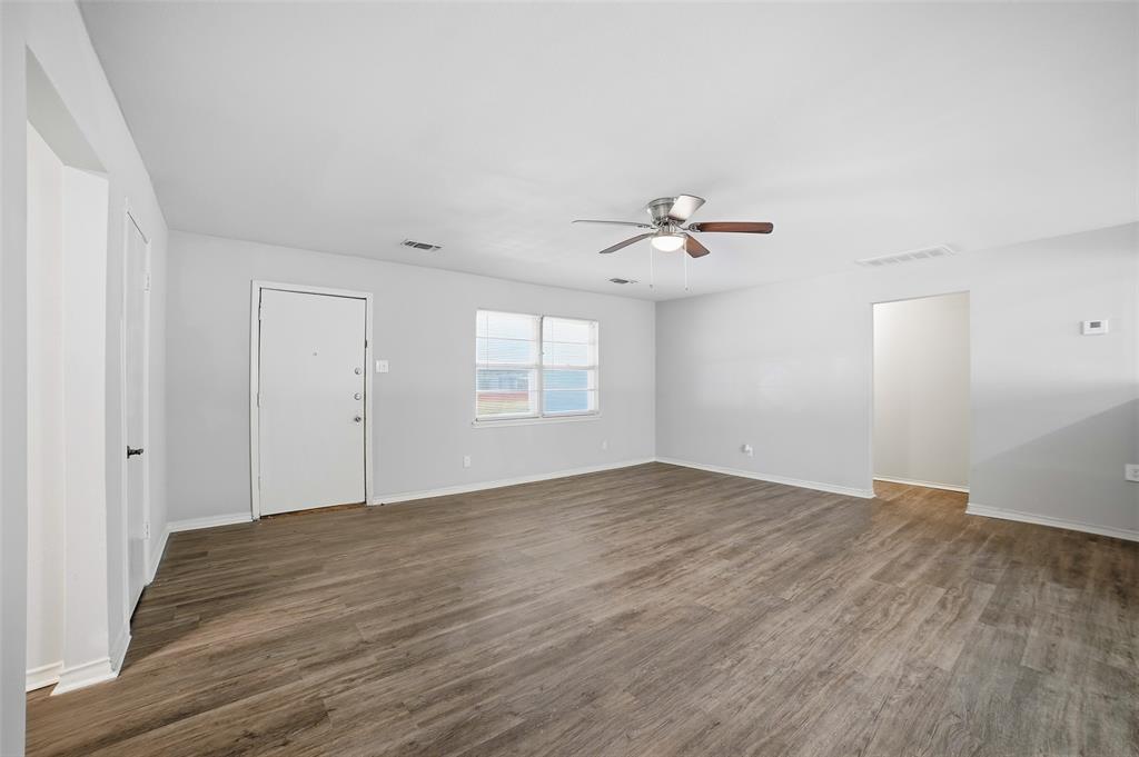 2926 North Prairie Creek Road Dallas, TX 75227 - Photo 7 of 22 wooden floor in an empty room with a window