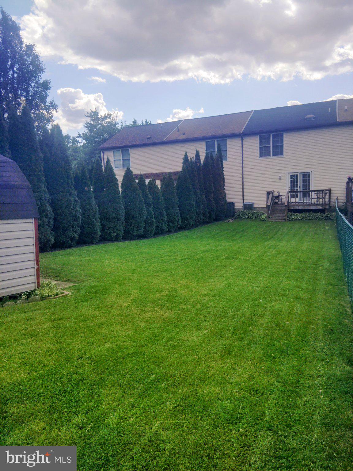69 Johnson Smithsburg, MD 21783 - Photo 9 of 39 a view of a backyard with potted plants and a large tree