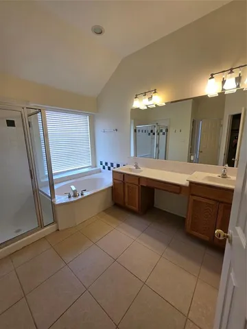 a room with a bed and a dresser