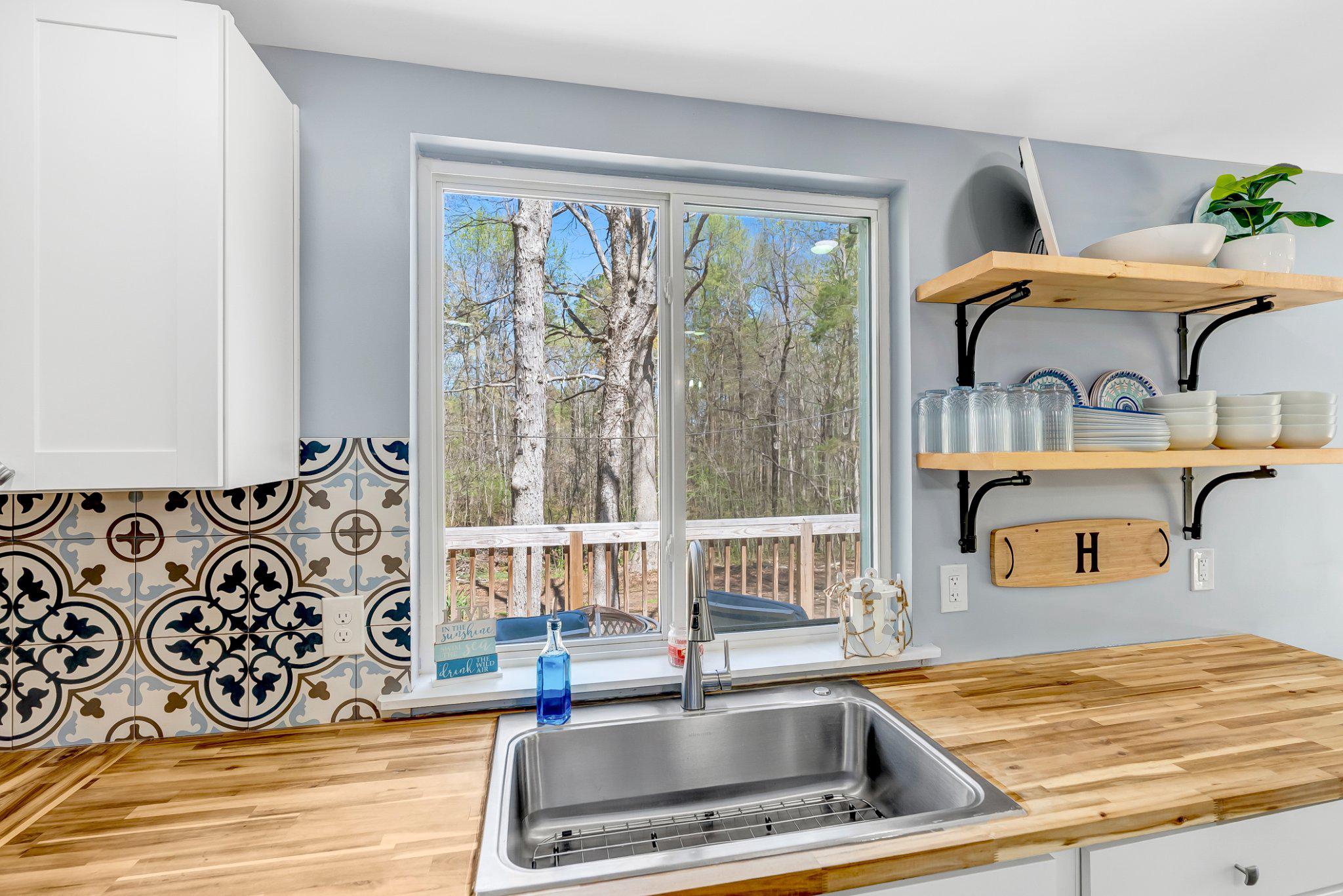 782 Mt Ararat Road Clarksville, VA 23927 - Photo 13 of 28 a kitchen with a stove a sink and a window