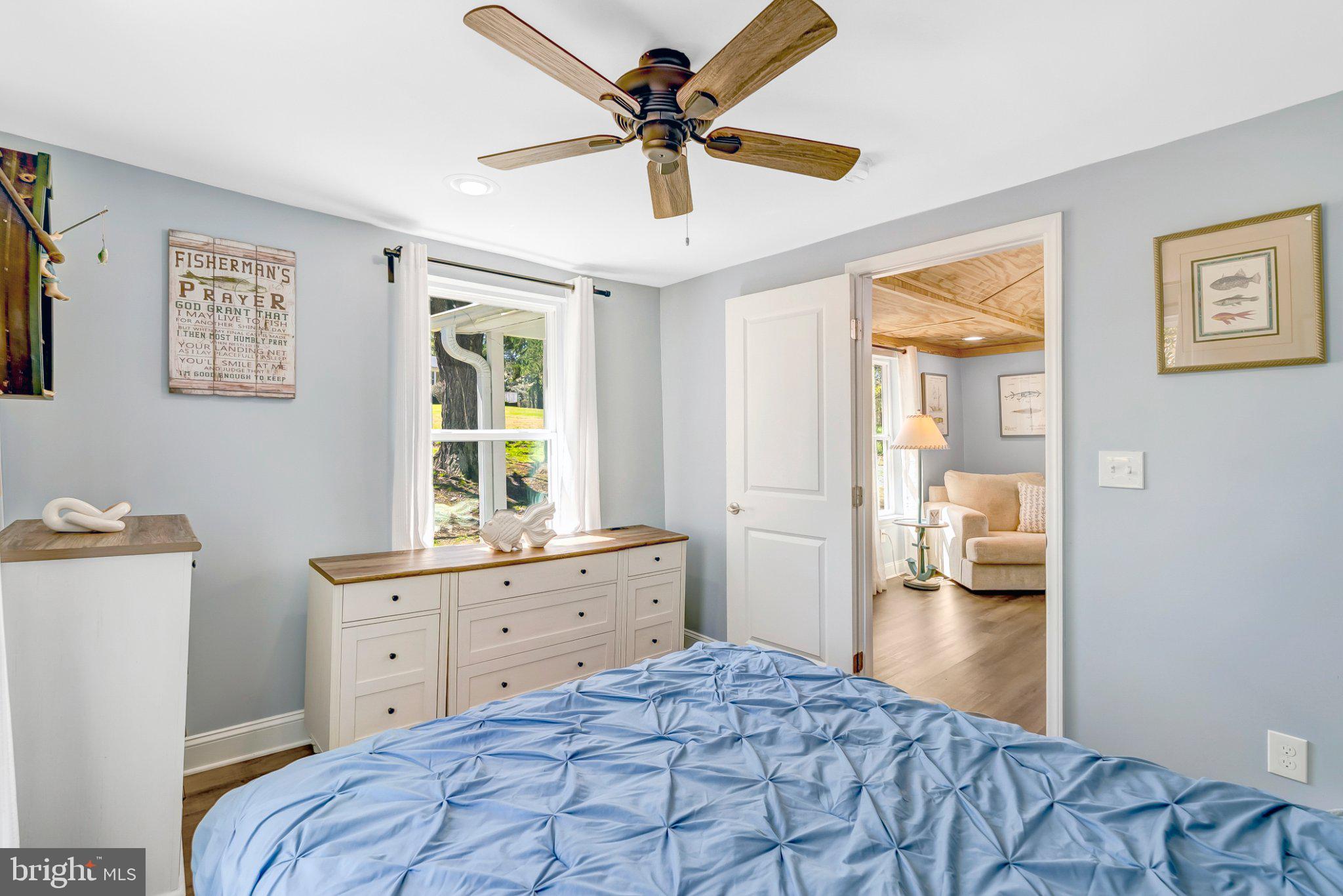 782 Mt Ararat Road Clarksville, VA 23927 - Photo 18 of 28 a bedroom with a bed and a chandelier fan