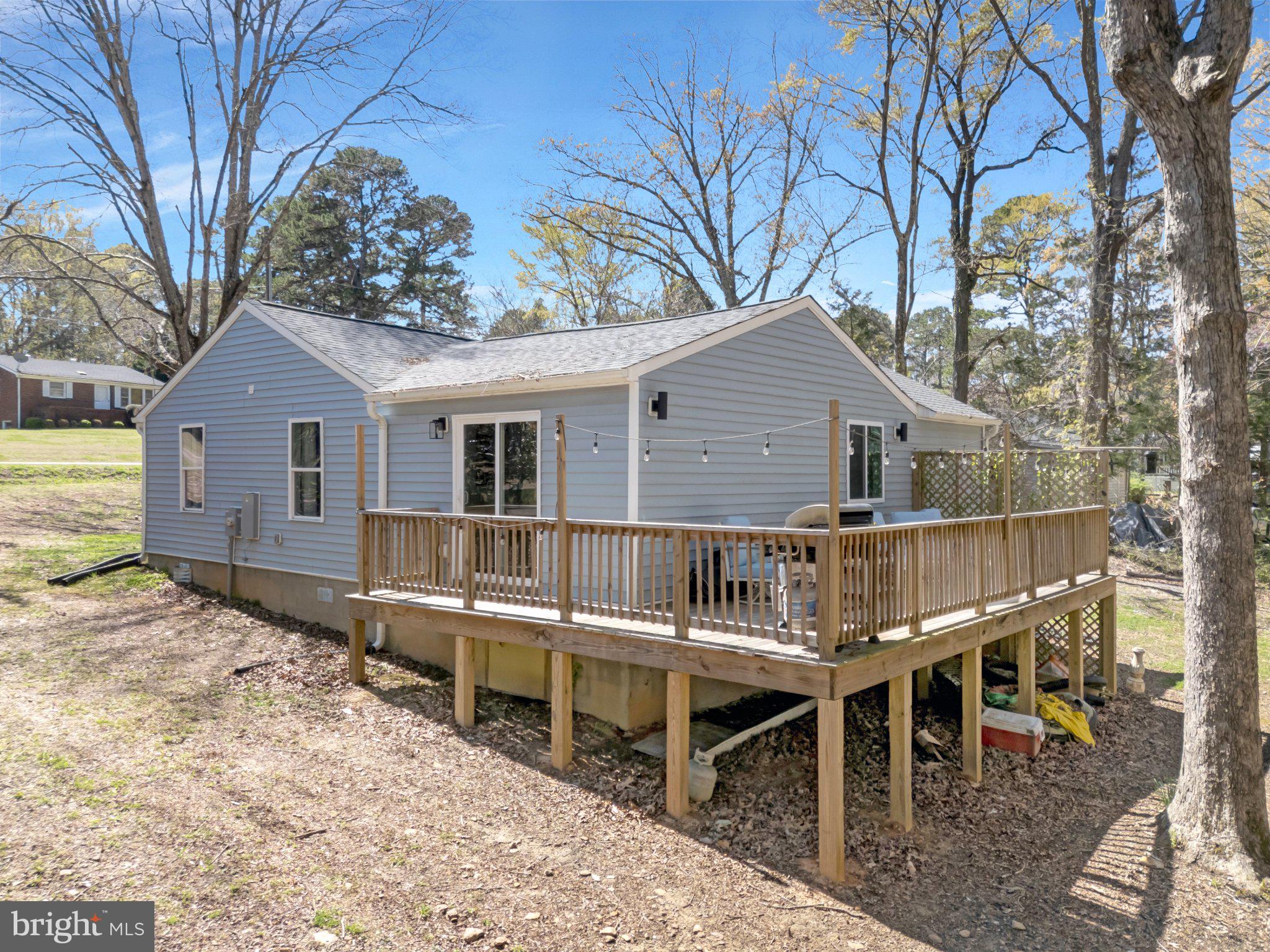 782 Mt Ararat Road Clarksville, VA 23927 - Photo 25 of 28 a view of a house with a wooden bench and floor to ceiling window