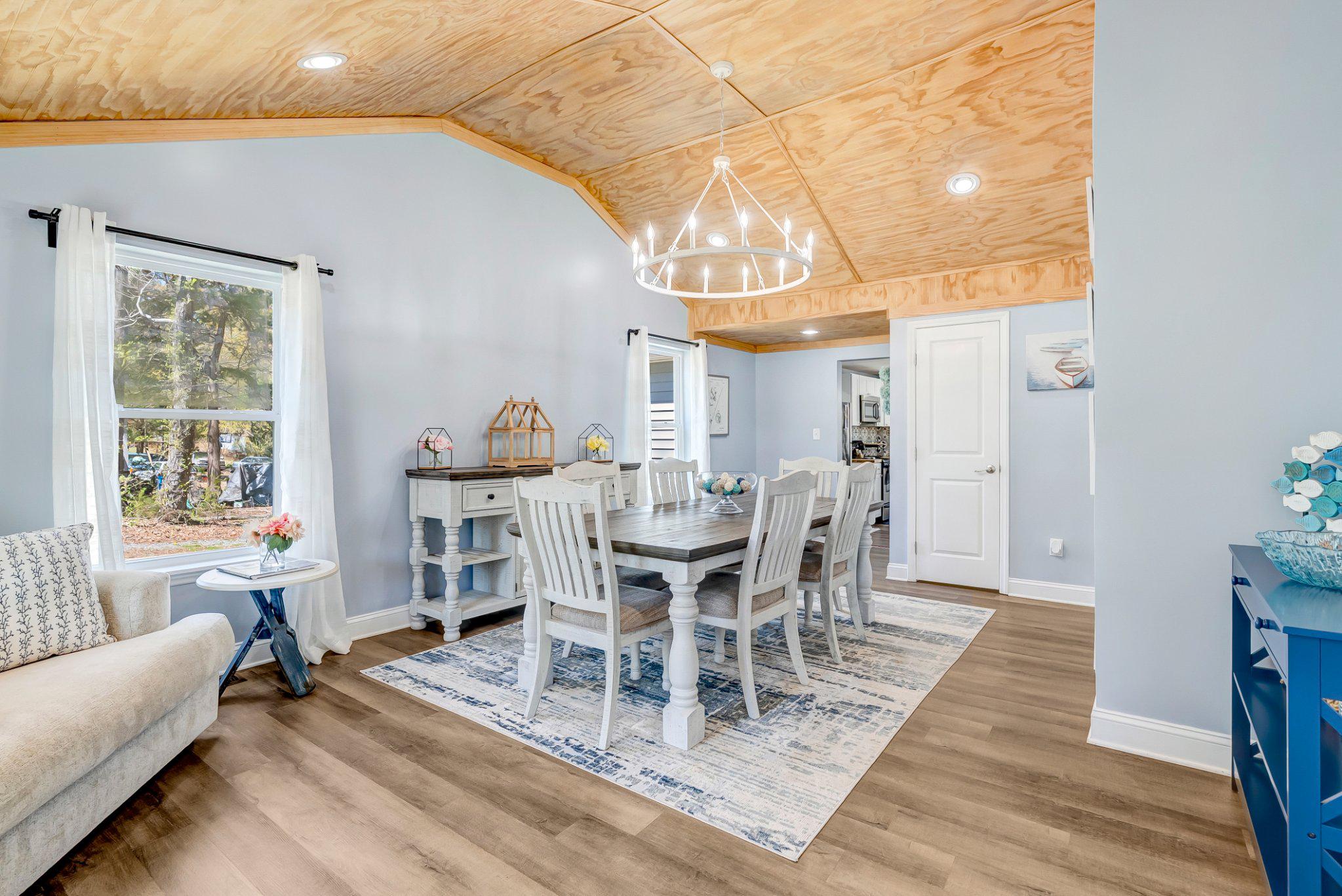 782 Mt Ararat Road Clarksville, VA 23927 - Photo 9 of 28 a view of a dining room with furniture a chandelier and wooden floor