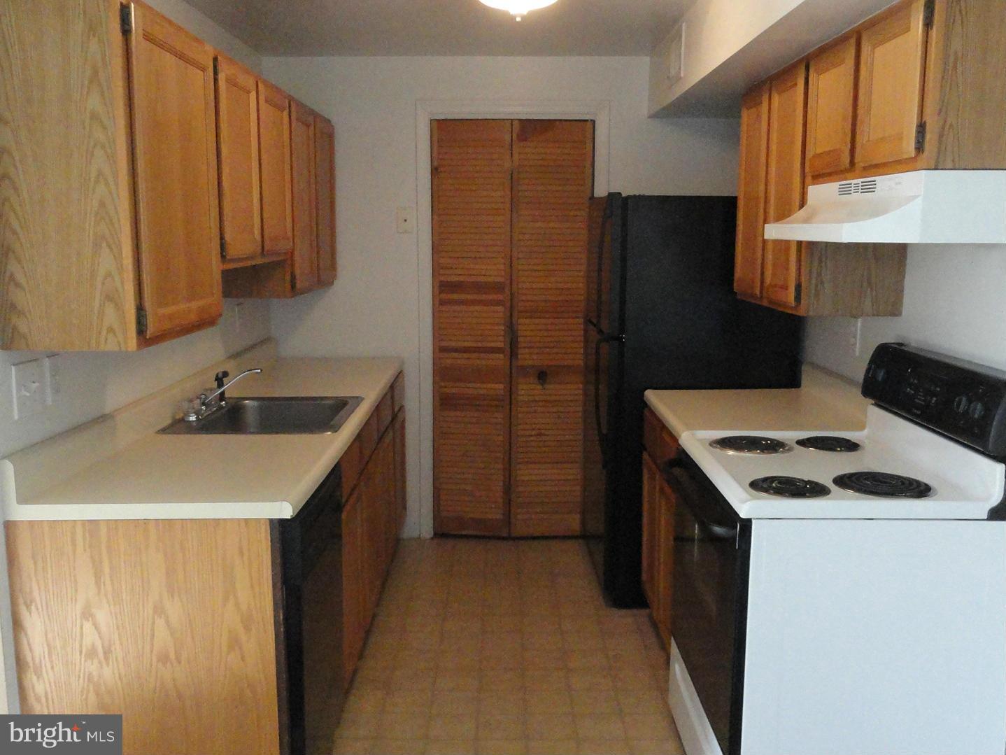 39 Coliston Road, Unit B Reisterstown, MD 21136 - Photo 7 of 20 a kitchen with a sink stove and refrigerator