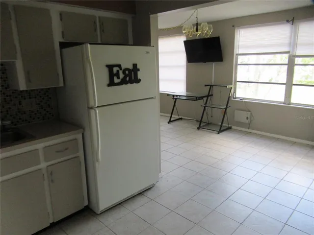 a view of a utility room with cabinets