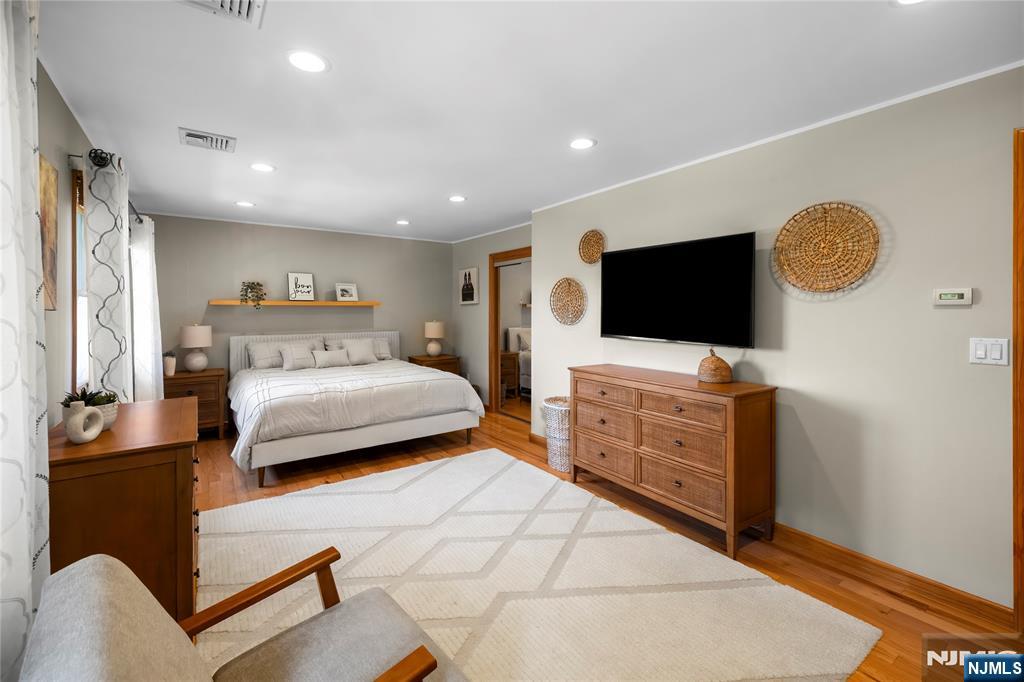 66 Roehrs Drive Wallington, NJ 07057 - Photo 12 of 37 a bedroom with furniture and a flat screen tv