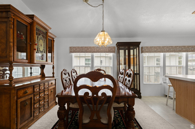 2600 North Hill Field Road, Unit 134 Layton, UT 84041 - Photo 9 of 41 Dining room featuring light flooring, plenty of natural light, and a chandelier
