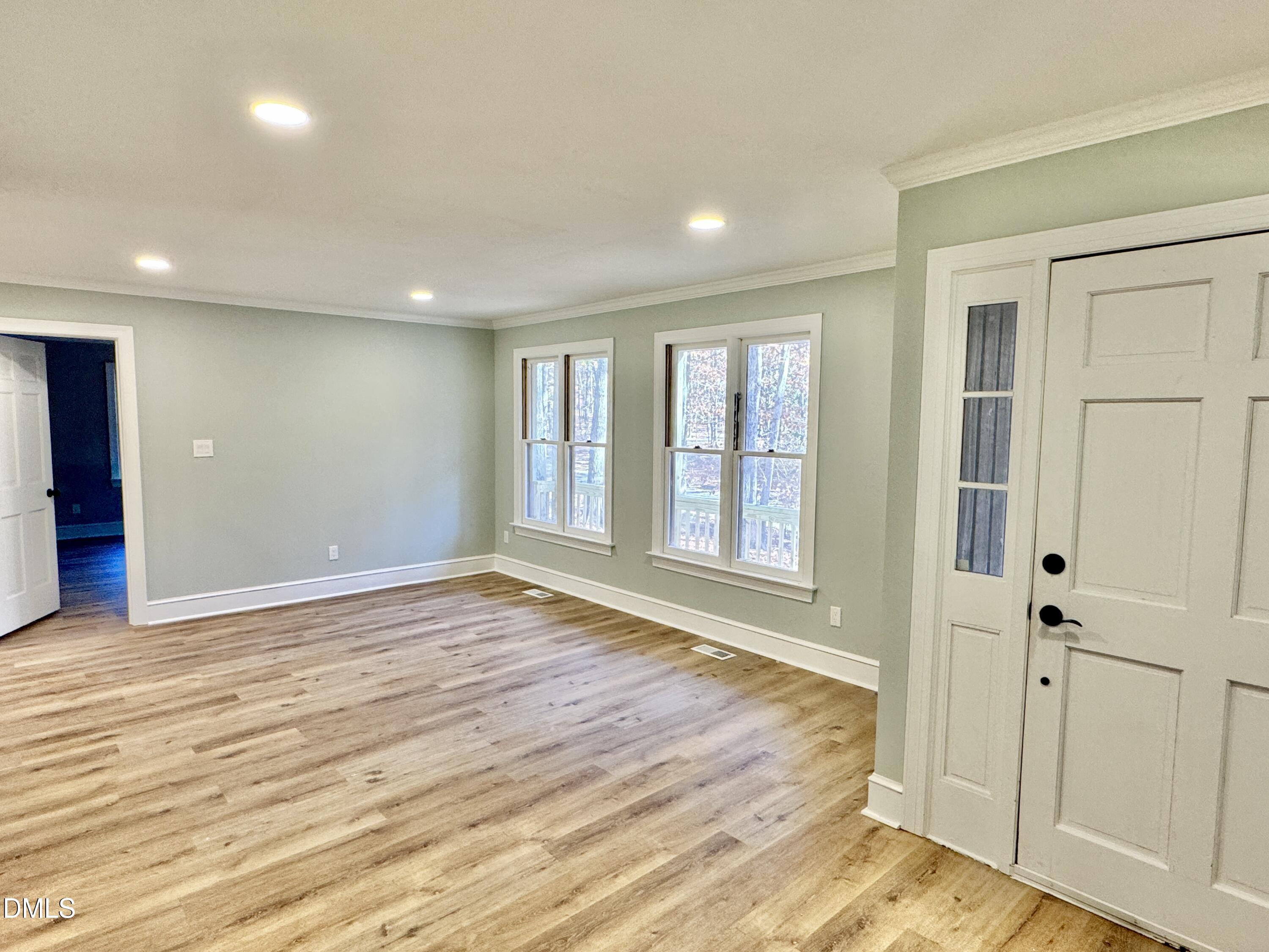 3412 Hackney Court Raleigh, NC 27613 - Photo 11 of 27 an empty room with wooden floor and windows