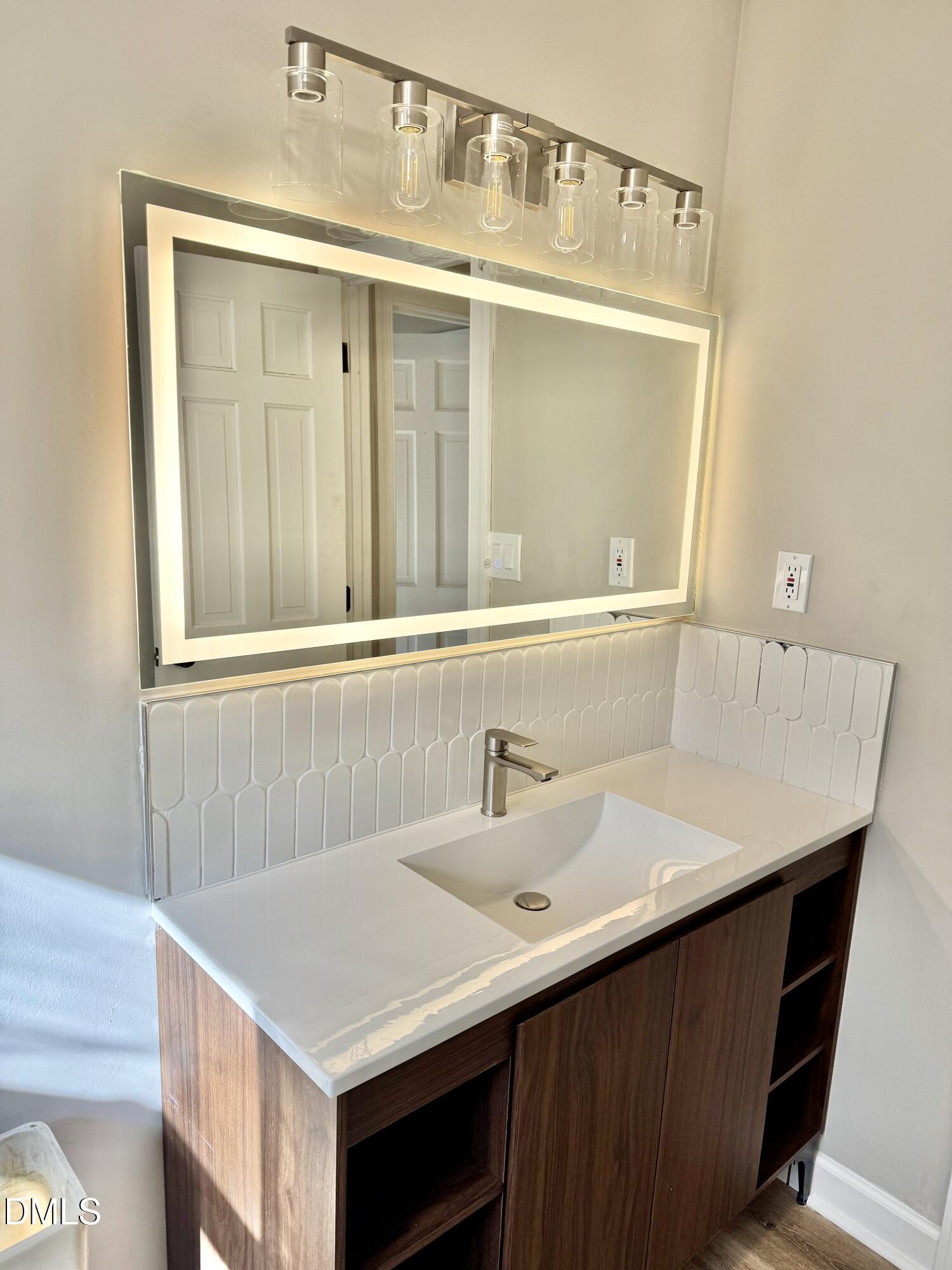 3412 Hackney Court Raleigh, NC 27613 - Photo 14 of 27 a bathroom with a sink and a mirror