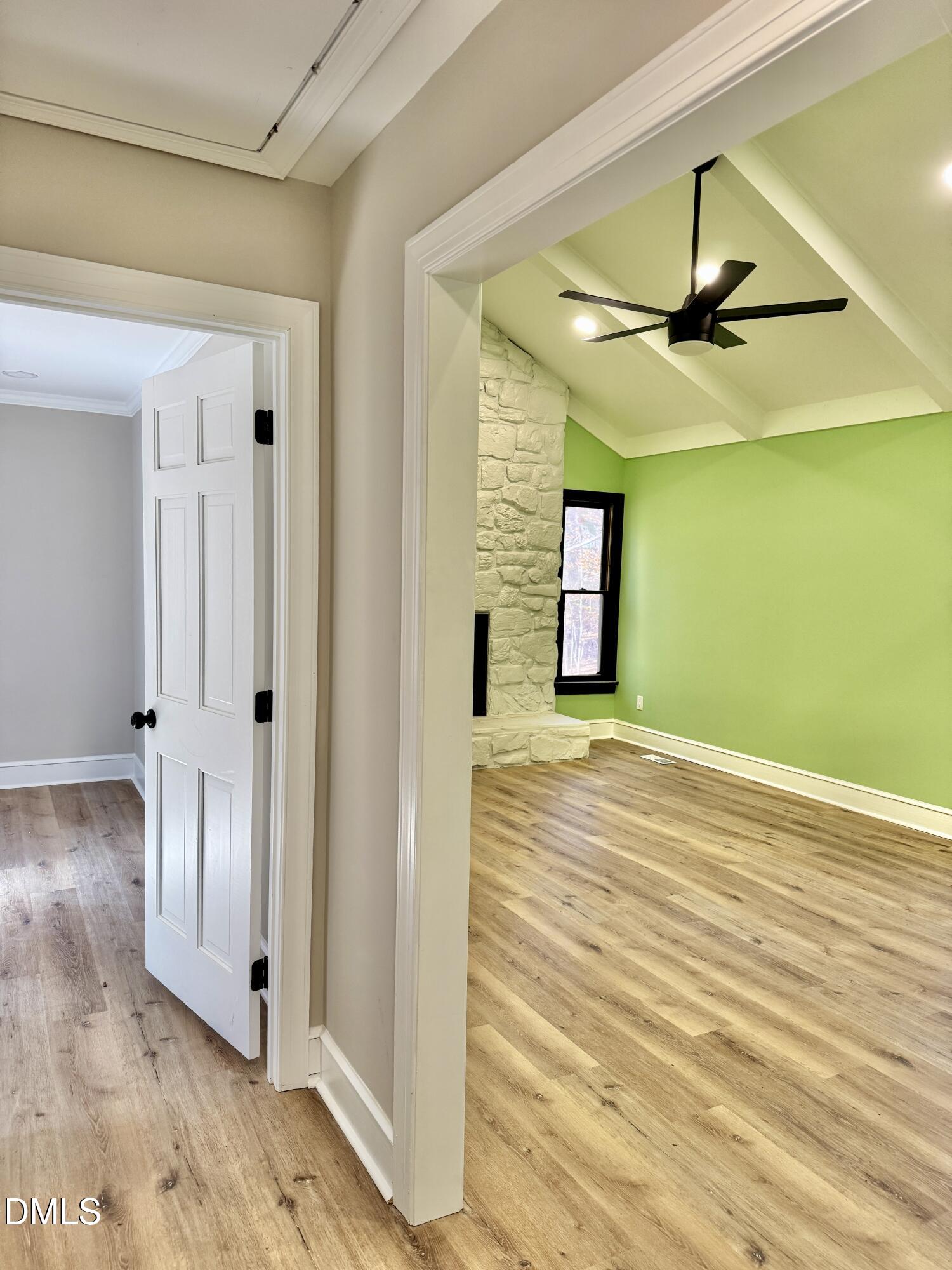 3412 Hackney Court Raleigh, NC 27613 - Photo 15 of 27 a view of a hallway with wooden floor and staircase
