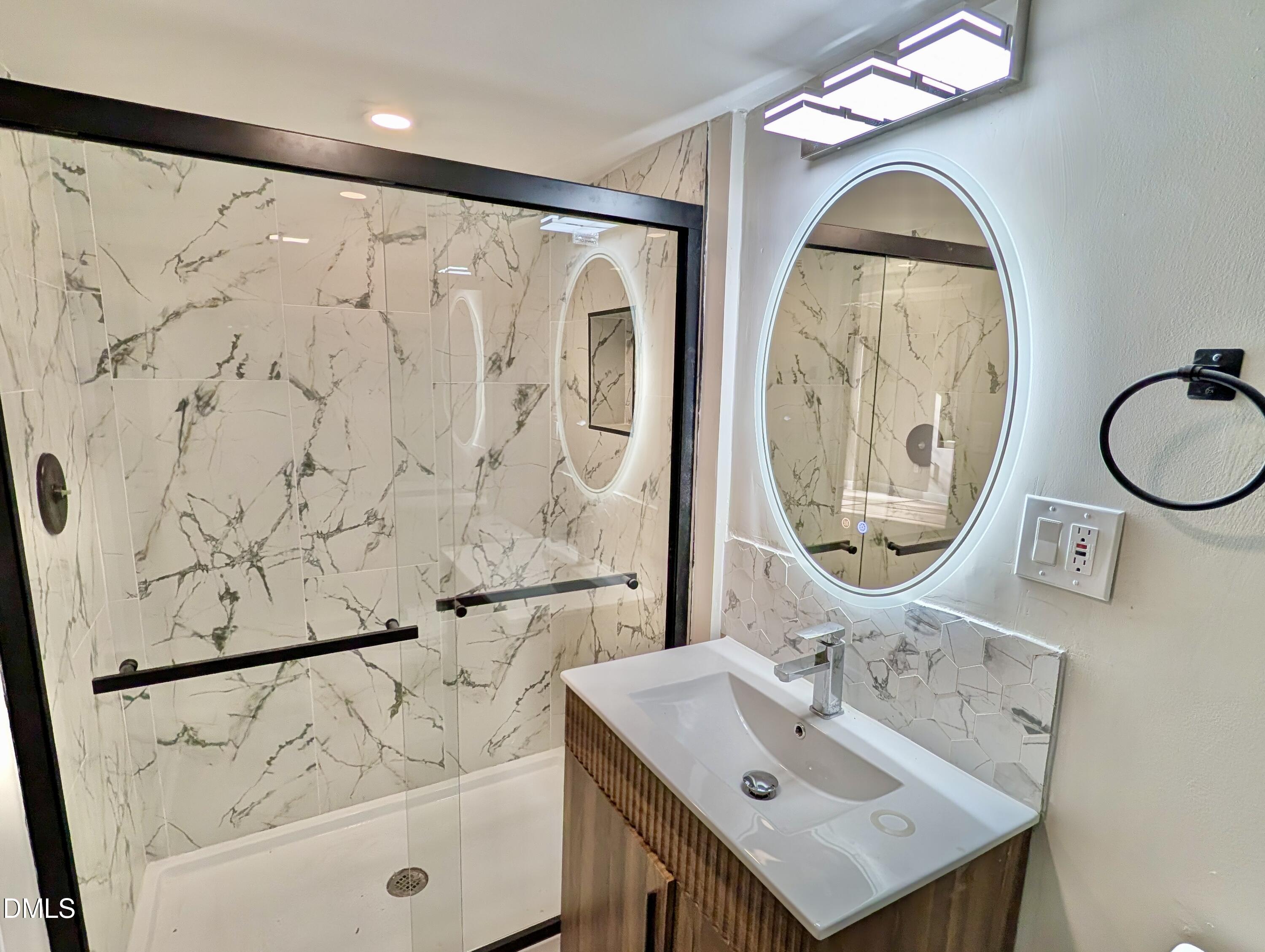 3412 Hackney Court Raleigh, NC 27613 - Photo 20 of 27 a bathroom with a sink and a mirror