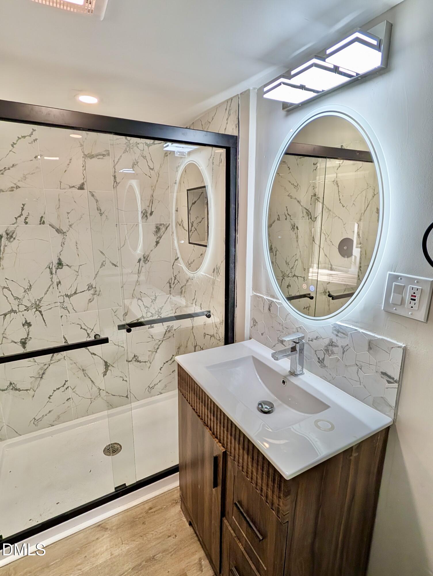 3412 Hackney Court Raleigh, NC 27613 - Photo 22 of 27 a bathroom with a sink and a mirror