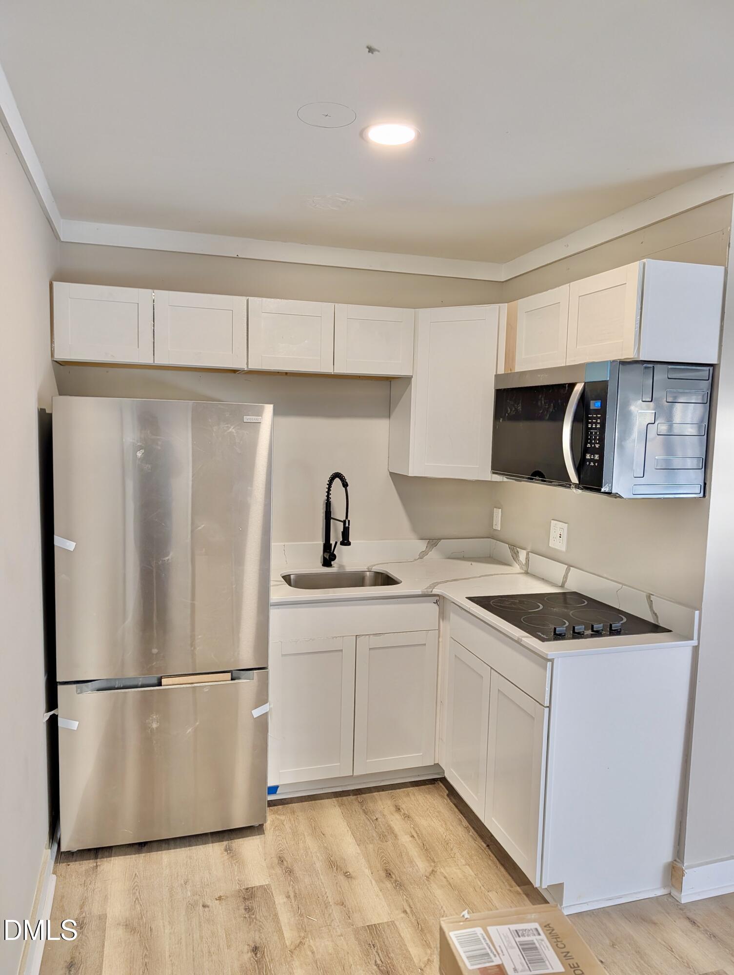 3412 Hackney Court Raleigh, NC 27613 - Photo 23 of 27 a kitchen with stainless steel appliances a refrigerator sink and microwave