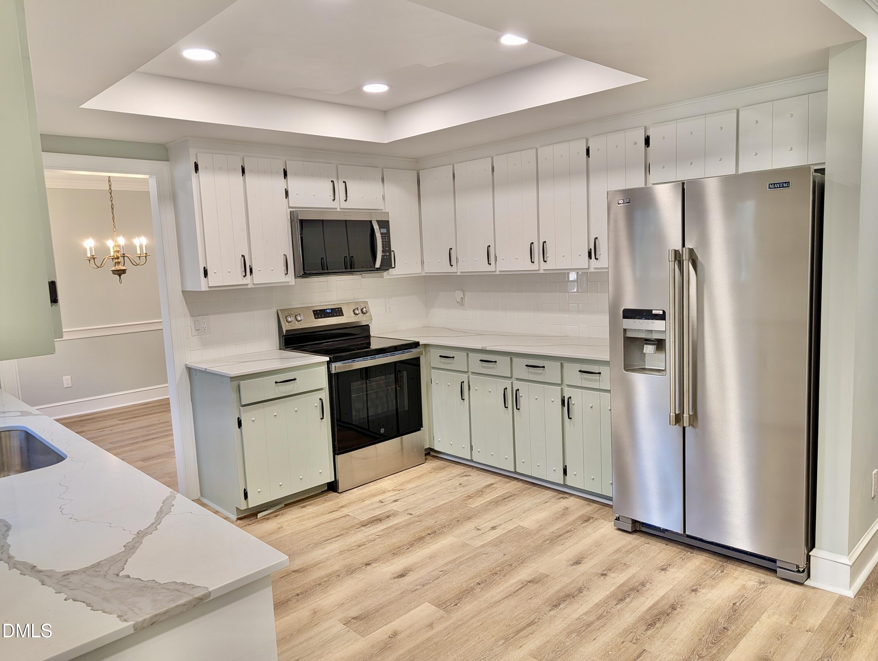 3412 Hackney Court Raleigh, NC 27613 - Photo 26 of 27 a kitchen with a sink a stove a refrigerator and a refrigerator