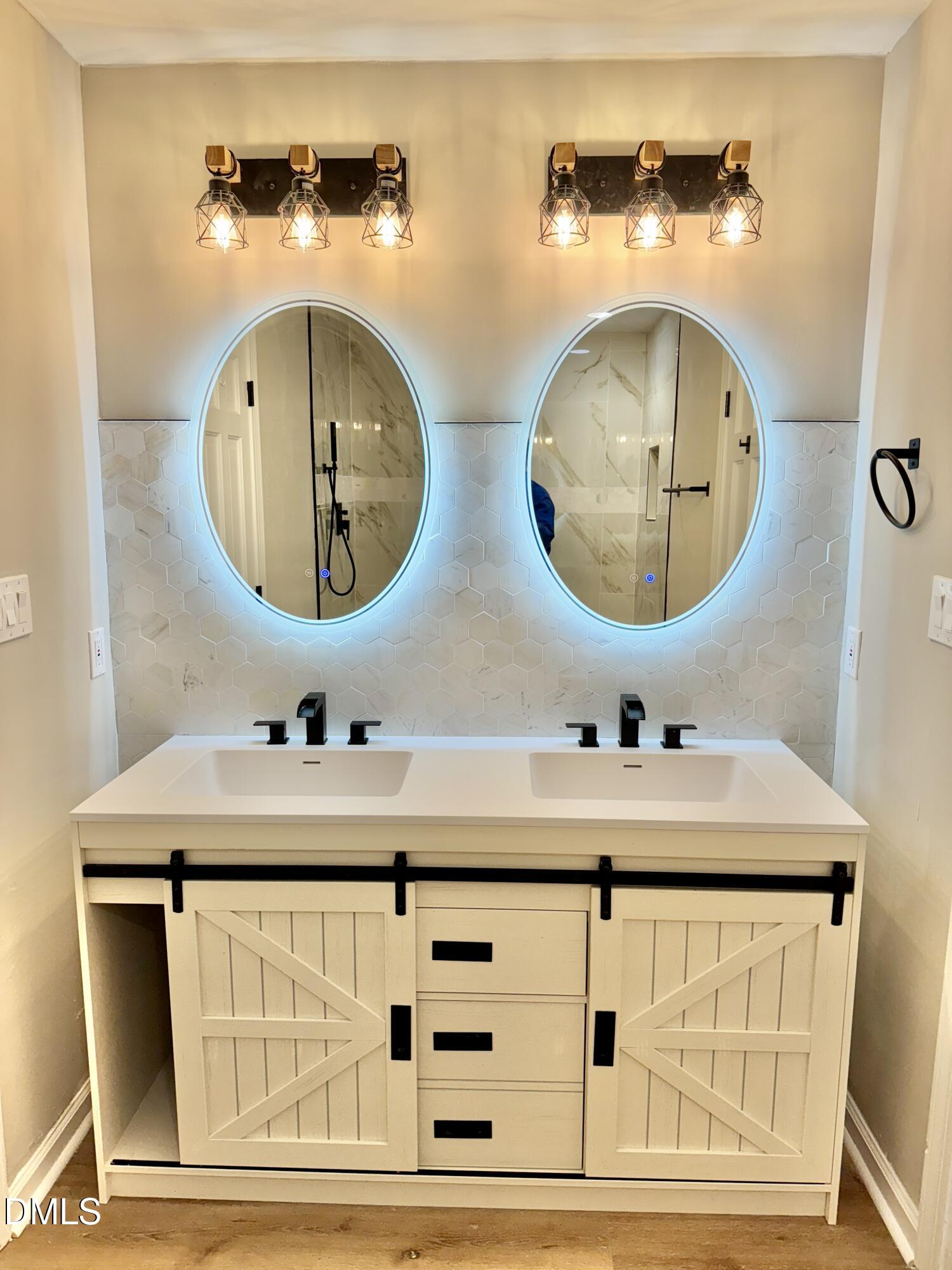 3412 Hackney Court Raleigh, NC 27613 - Photo 4 of 27 a bathroom with a sink and a mirror