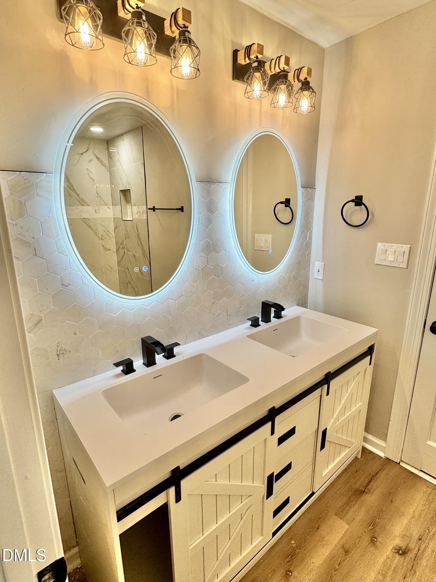 3412 Hackney Court Raleigh, NC 27613 - Photo 9 of 27 a bathroom with a sink and a mirror