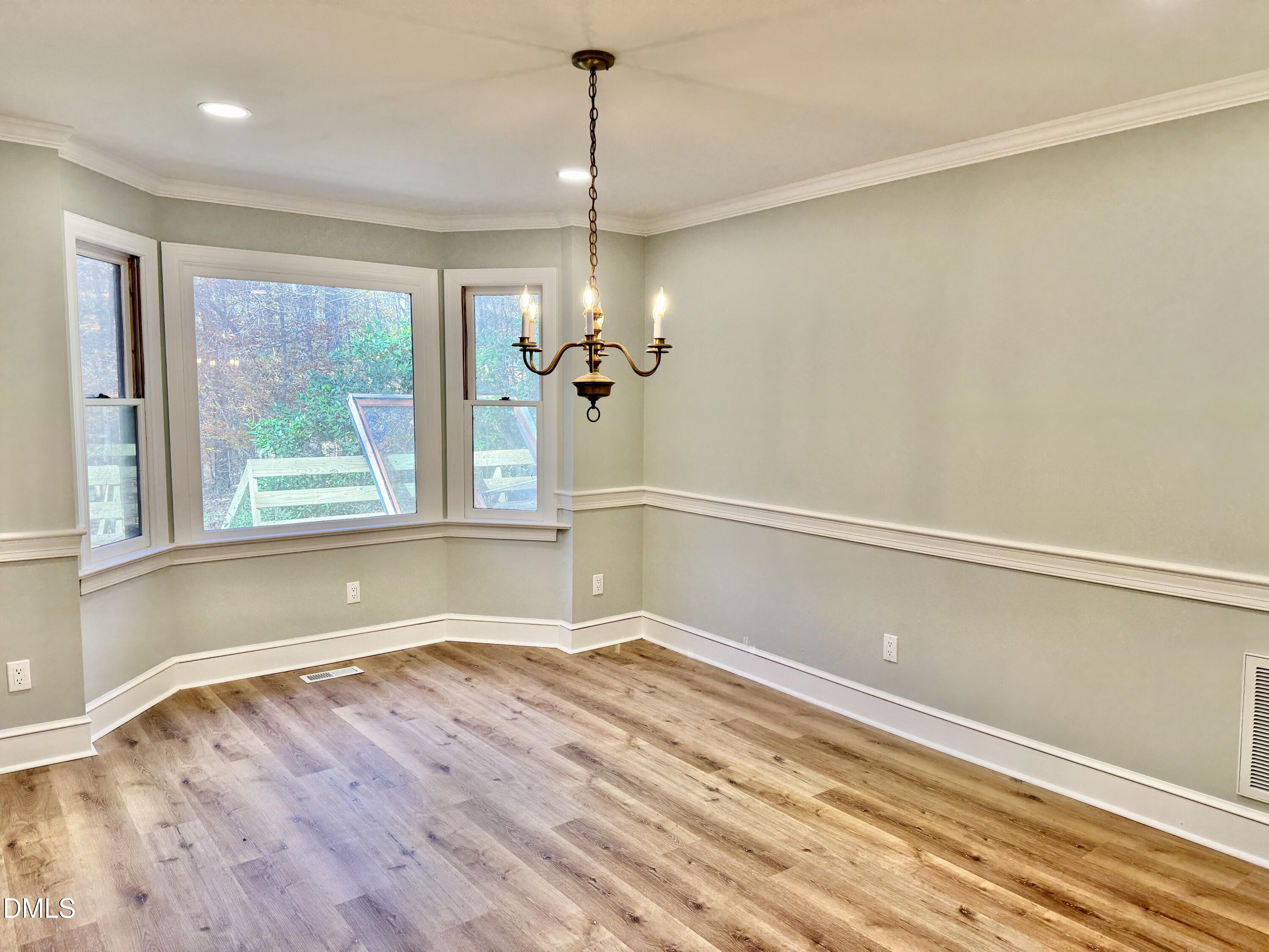 3412 Hackney Court Raleigh, NC 27613 - Photo 10 of 27 a view of a room with wooden floor and a window