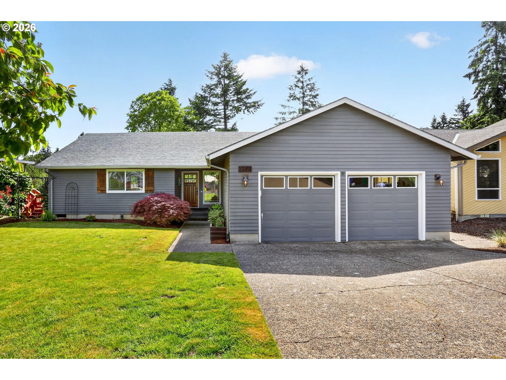 1776 Southeast 114th Place Portland, OR 97216 - Photo 2 of 47 a front view of a house with a garden and yard