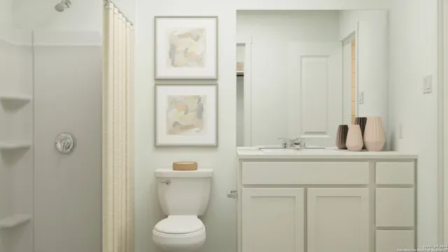 a bathroom with a toilet sink vanity and mirror