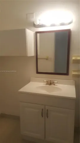 a bathroom with a sink and mirror