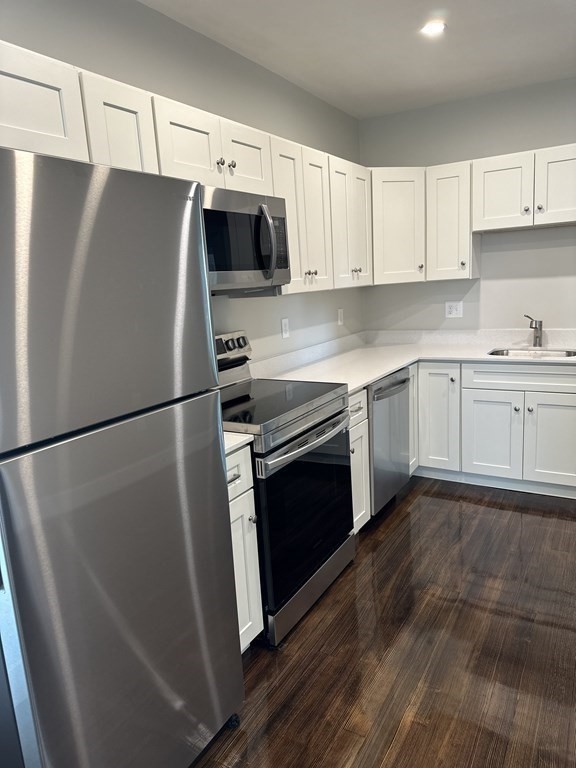 15 Tuttle Street, Unit 2 Revere, MA 02151 - Photo 4 of 17 a kitchen with stainless steel appliances a refrigerator stove and microwave