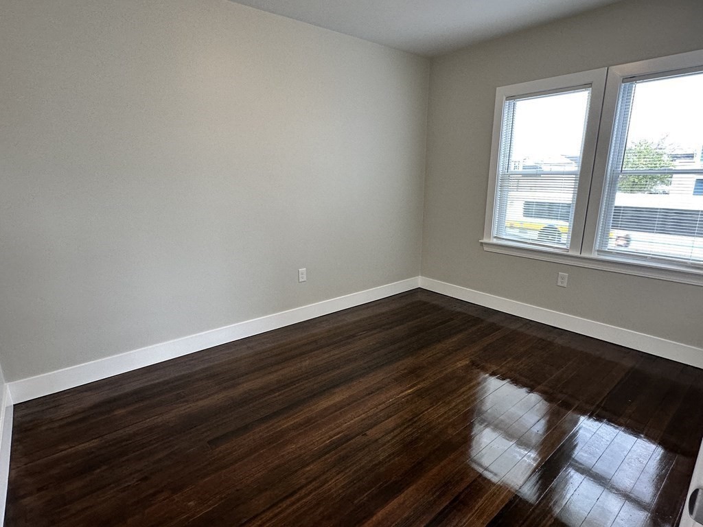 15 Tuttle Street, Unit 2 Revere, MA 02151 - Photo 5 of 17 a view of an empty room with wooden floor and a window