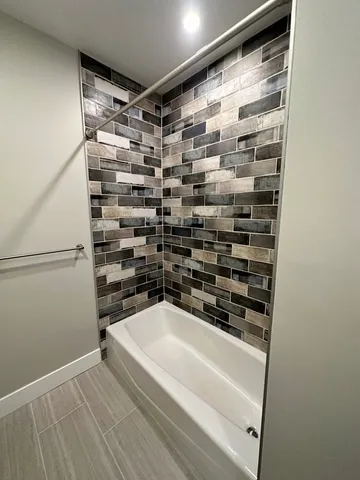 a bathroom with a shower and a sink