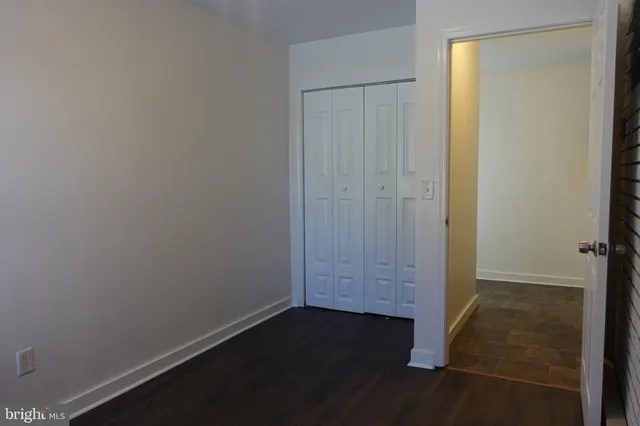 an empty room with closet area
