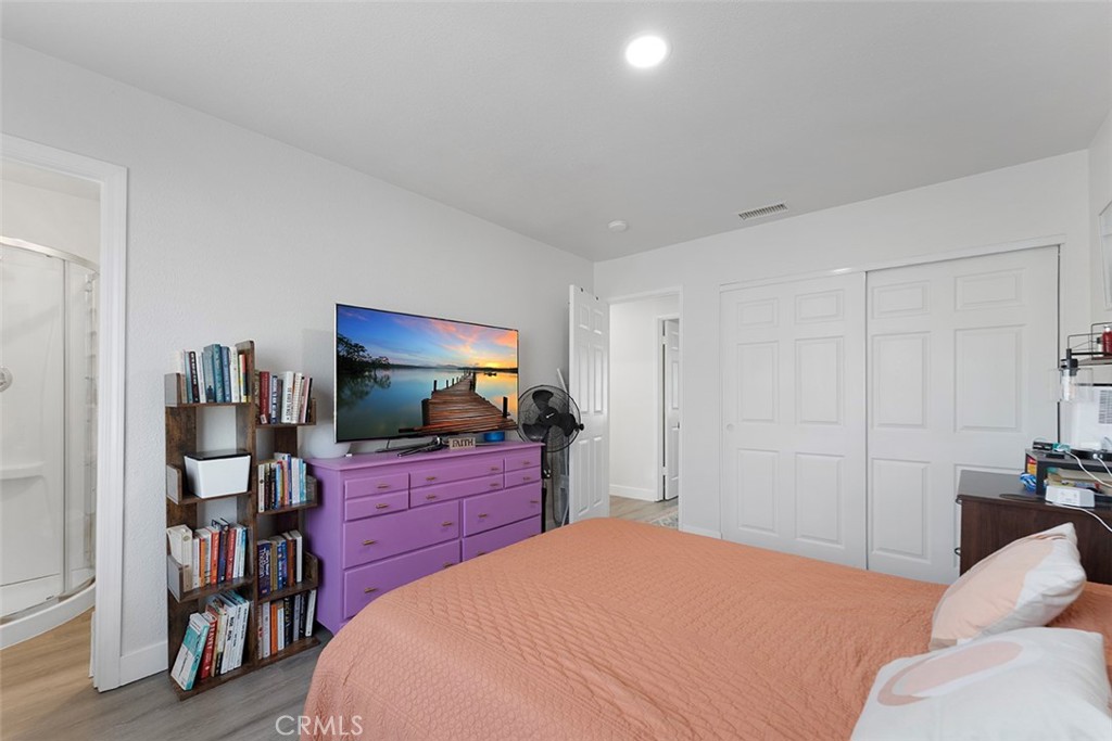9595 Altadena Drive Riverside, CA 92503 - Photo 16 of 31 Primary bedroom with recessed lighting and en suite. Bedroom faces the backyard.