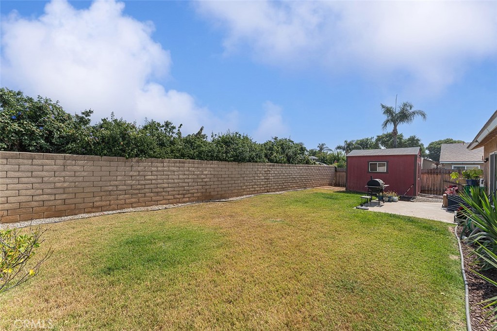 9595 Altadena Drive Riverside, CA 92503 - Photo 19 of 31 Spacious backyard with block wall and distance fence is wood. Large barn shed for extra storage.