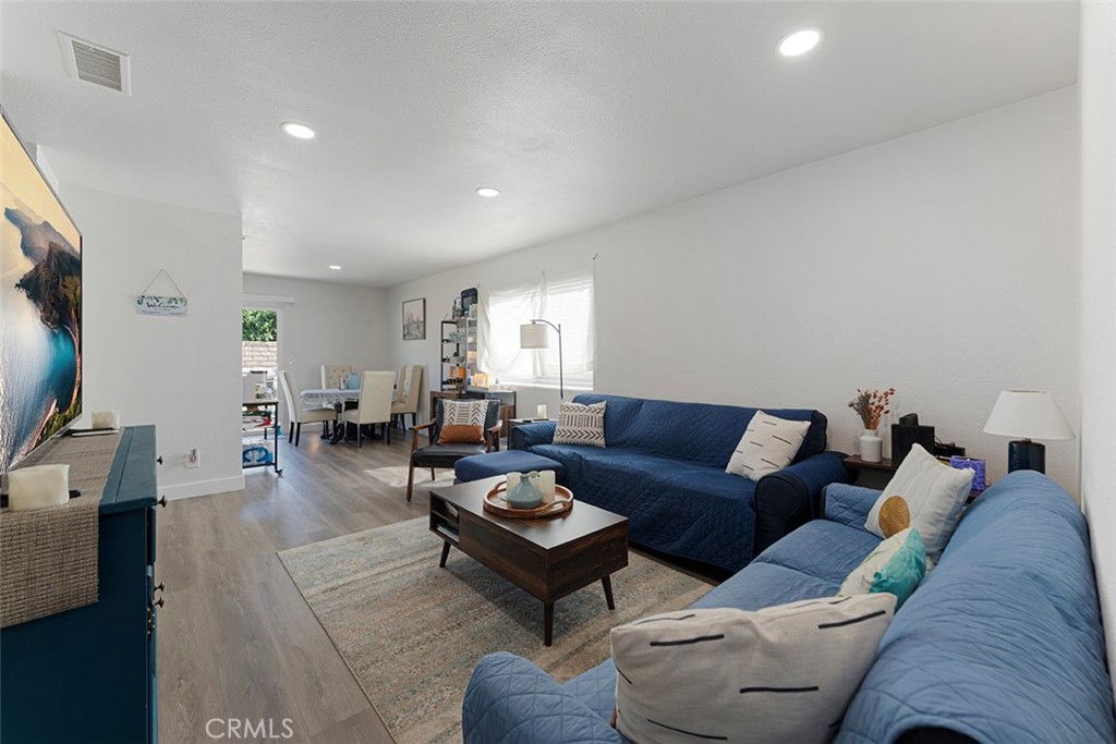 9595 Altadena Drive Riverside, CA 92503 - Photo 2 of 31 Standing from the entrance looking onward to the living room/dining. Vinyl plank flooring, recessed lighting.