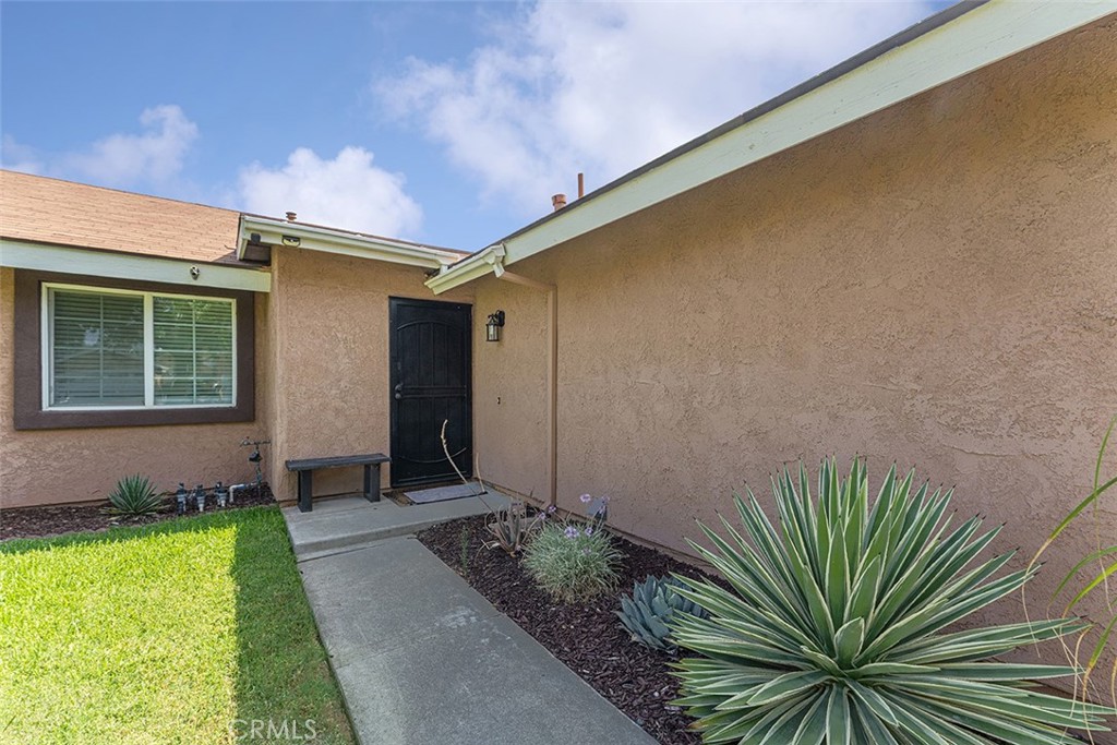 9595 Altadena Drive Riverside, CA 92503 - Photo 21 of 31 Path leads to the entrance. Window belongs to the first bedroom on the right hand side of the hallway.