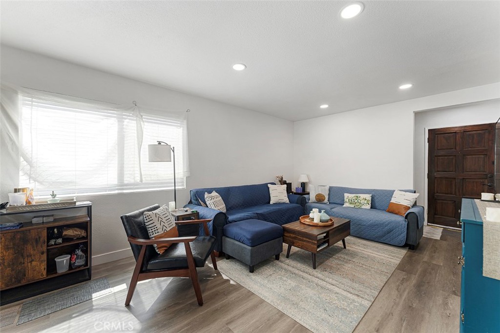 9595 Altadena Drive Riverside, CA 92503 - Photo 3 of 31 Vinyl plank flooring, recessed lighting. Entrance right of image. Hallway to the left. Standing from dining/kitchen area.