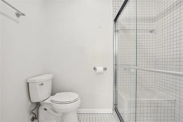 a bathroom with a toilet and a shower
