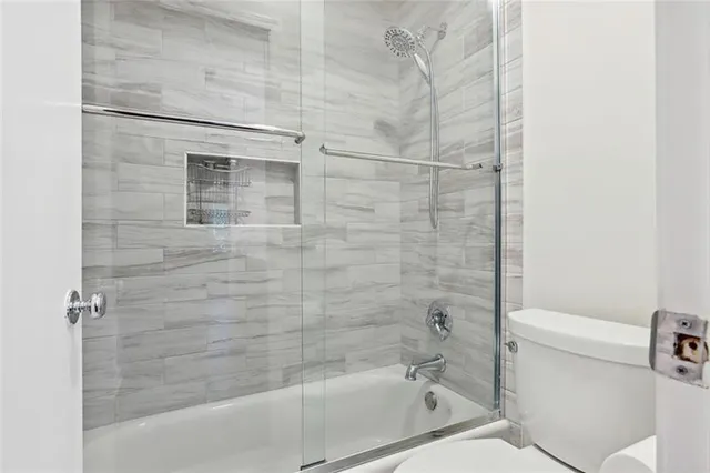 a bathroom with a bathtub and a toilet