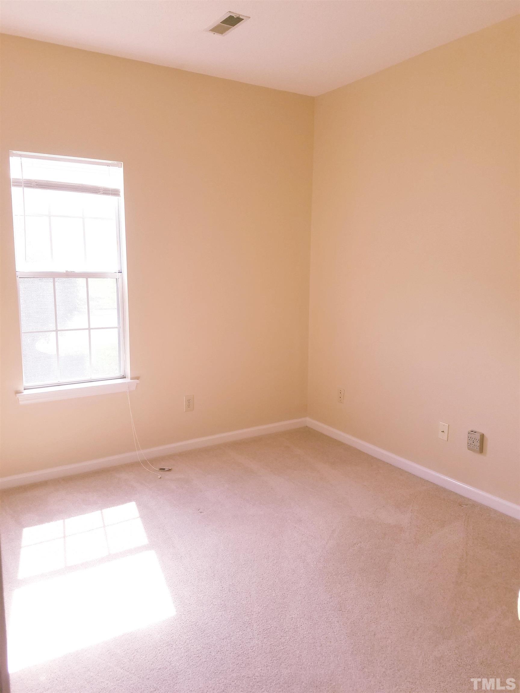 1815 Collier Road Durham, NC 27707 - Photo 13 of 14 an empty room with a window
