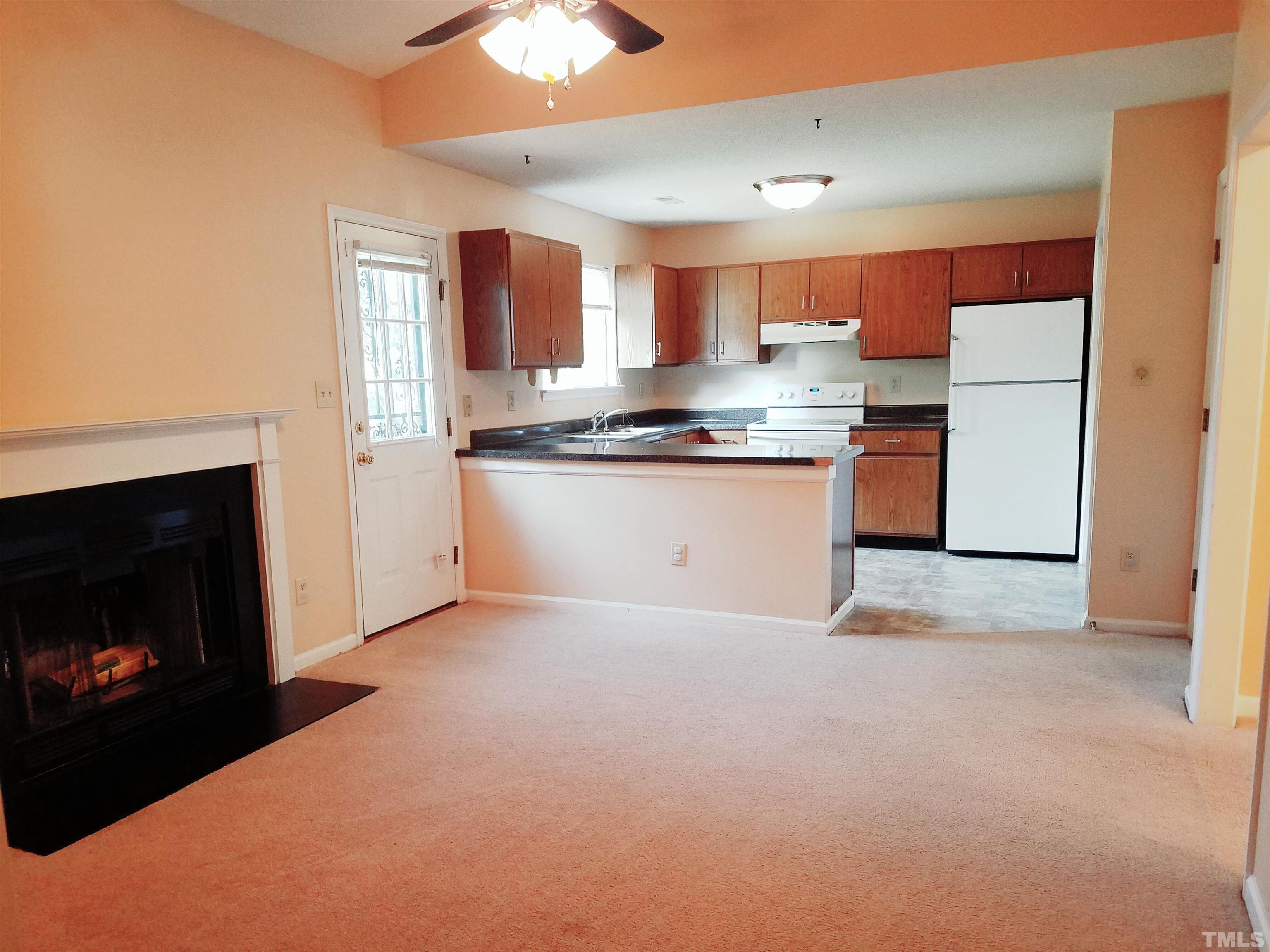 1815 Collier Road Durham, NC 27707 - Photo 3 of 14 a kitchen with stainless steel appliances granite countertop a stove a sink and a refrigerator