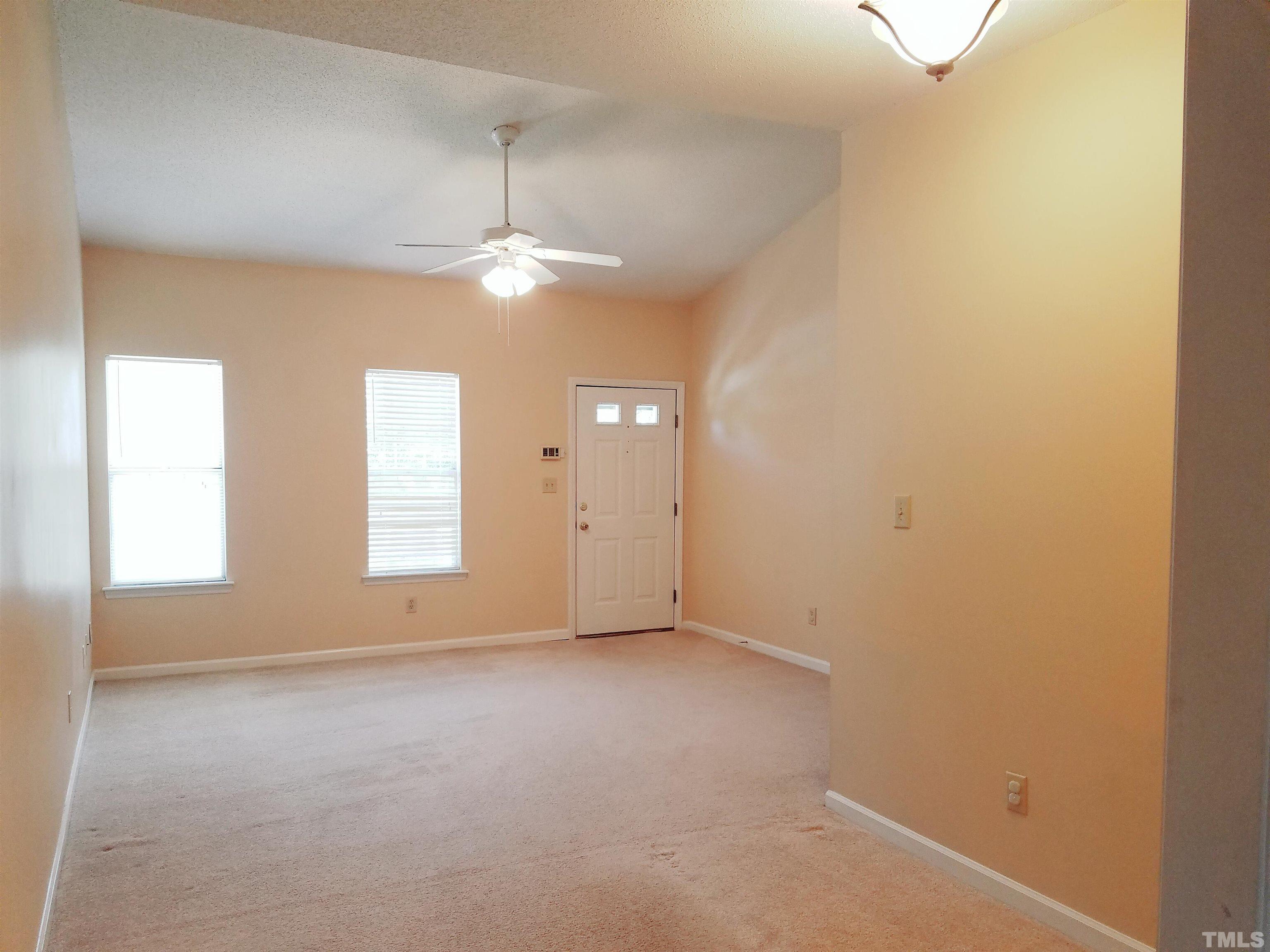 1815 Collier Road Durham, NC 27707 - Photo 4 of 14 an empty room with windows and ceiling fan