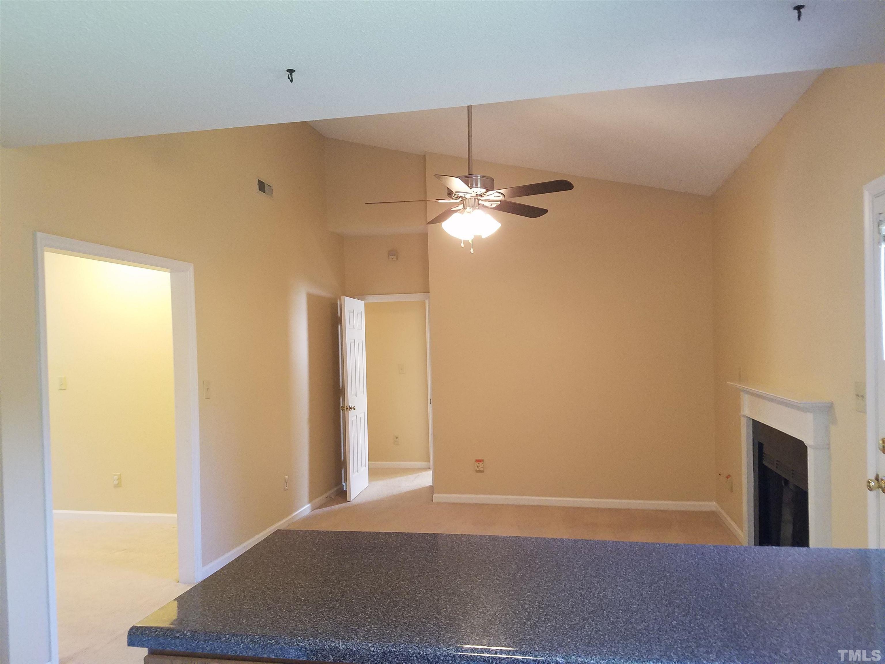 1815 Collier Road Durham, NC 27707 - Photo 7 of 14 a view of a livingroom with a chandelier fan and a fireplace