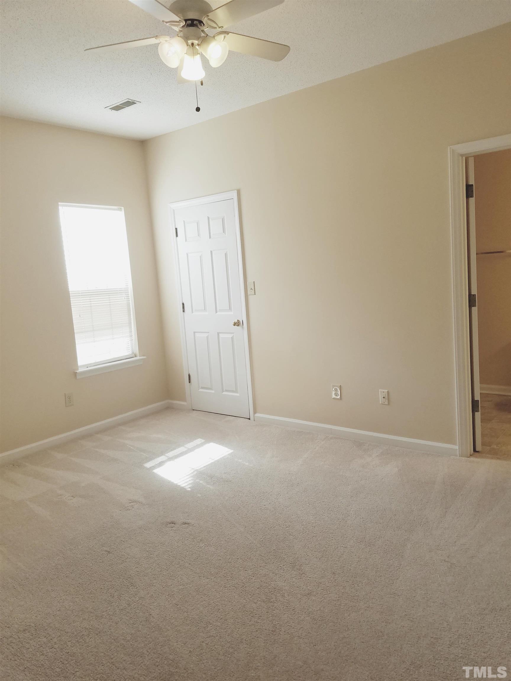 1815 Collier Road Durham, NC 27707 - Photo 8 of 14 an empty room with a window and a ceiling fan