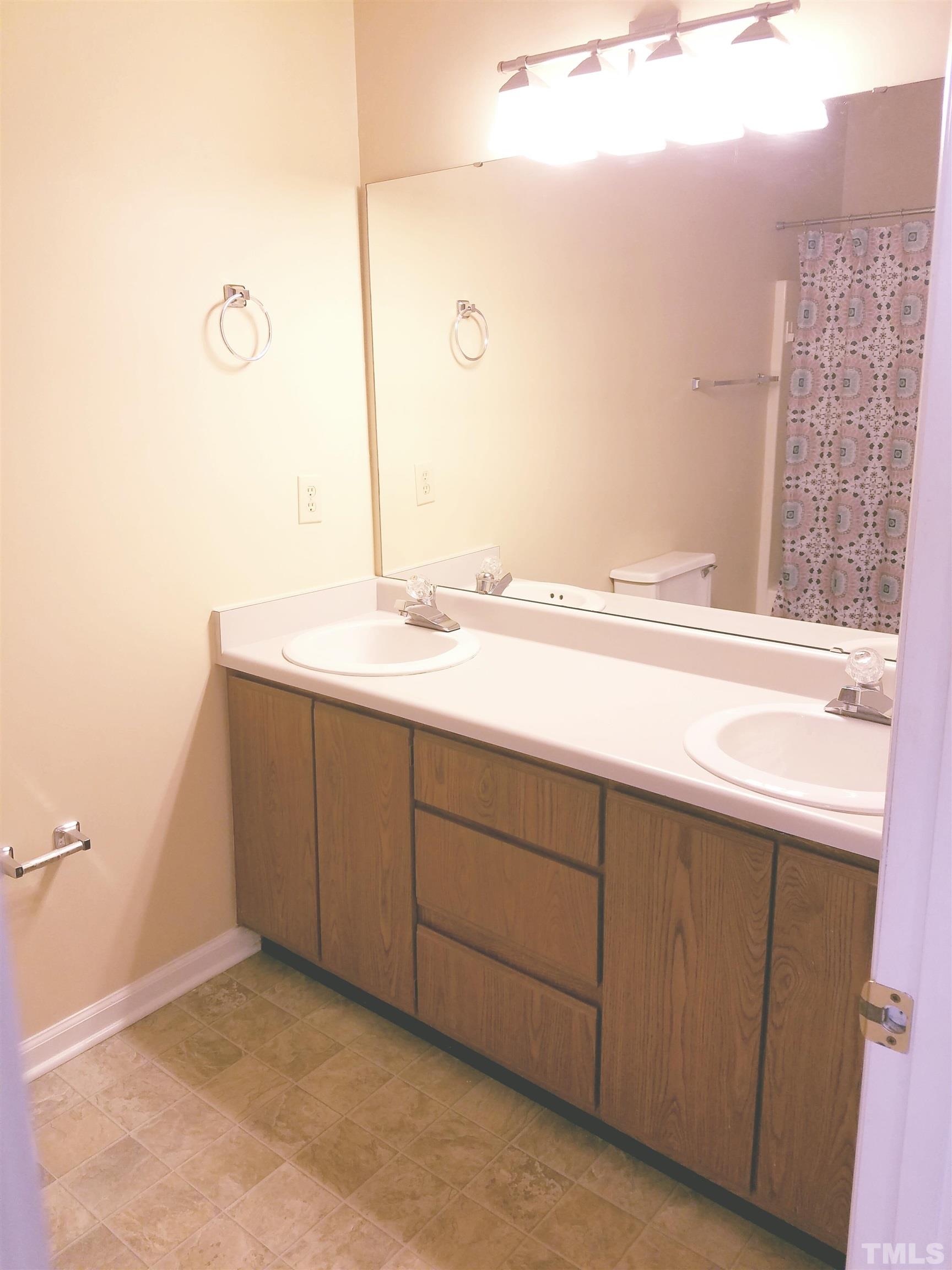 1815 Collier Road Durham, NC 27707 - Photo 10 of 14 a bathroom with a sink and a mirror