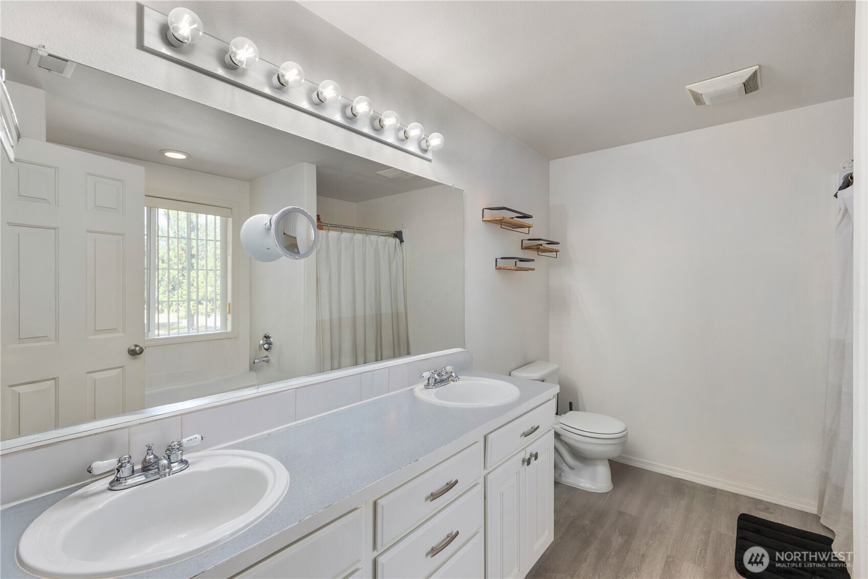 8305 Sweetbrier Loop Southeast Olympia, WA 98513 - Photo 33 of 40 a bathroom with a toilet a sink and mirror
