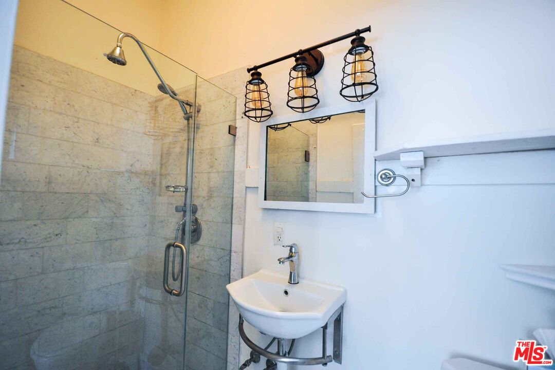 2315 2nd Street, Unit A Santa Monica, CA 90405 - Photo 11 of 17 a bathroom with a sink and mirror
