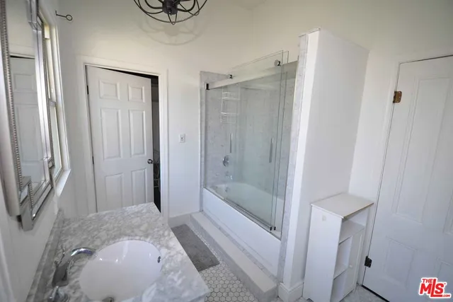 a bathroom with a shower and a sink